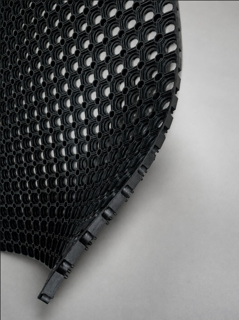 Black anti-trip safety ring mat with bevelled edges for slip-resistant and anti-fatigue workplace flooring.