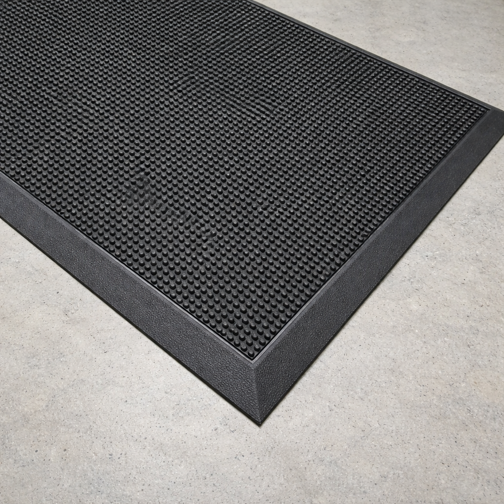 Black rubber anti-fatigue mat with textured grip surface and beveled edge